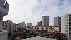 A cityscape with high-rise buildings and a mix of residential and commercial structures. - Уютная квартира в Батуми с джакузи. (Batumi)