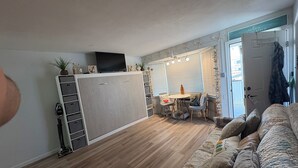 A compact living space with a kitchenette, a dining area, and a seating area with a sofa. - BEACH GETAWAY!! 🏖🏖🏖 (Wildwood Crest)