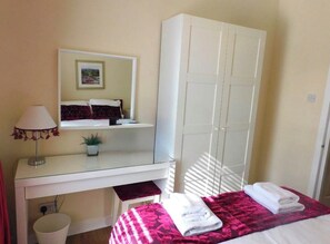 A bedroom with a bed, a wardrobe, a desk with a lamp, and a small plant. - Fabulous location, One Bedroom West End Flat, just off Byres rd, close to SEC & Hydro (Glasgow)