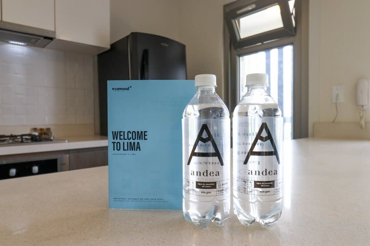A kitchen counter with two water bottles labeled 'andea' and a welcome sign for 'WELCOMED TO LIMA'.