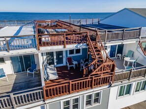 A multi-level deck with outdoor seating and a view of the ocean. - Oceanfront 3 Bedroom 3 Bath Vacation Rental in Ocean City MD | Direct Beach Access, Sealax Awhile (Ocean City)