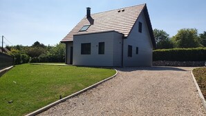 A single-story house with a sloped roof and a chimney.