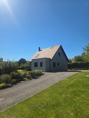 A single-story house with a sloped roof, a gravel driveway, and a well-maintained lawn. - Le Clos des Cajaviris 1 (Carly)