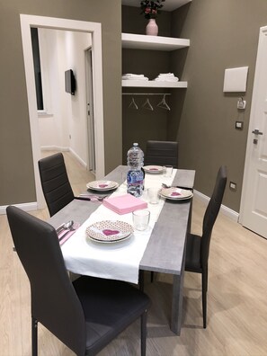 Enjoy meals with family and friends at this dining area, featuring a table for four and comfortable seating.