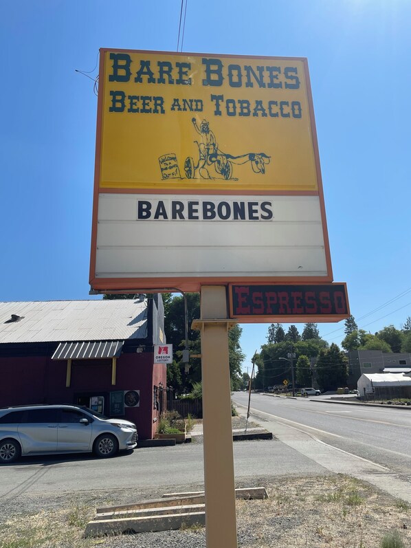 A sign for Bare Bones Beer and Tobacco, with a smaller sign below advertising espresso.
