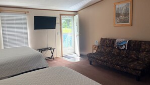 A hotel room with two beds, a television, a couch, and a door leading outside. - Stay In Ohiopyle near The Falls & GAP trail. (Ohiopyle)
