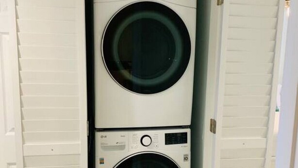 A laundry room with two stacked front-loading washing machines.