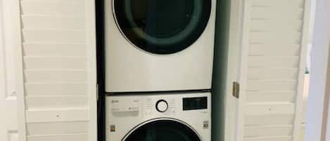A laundry room with two stacked front-loading washing machines.