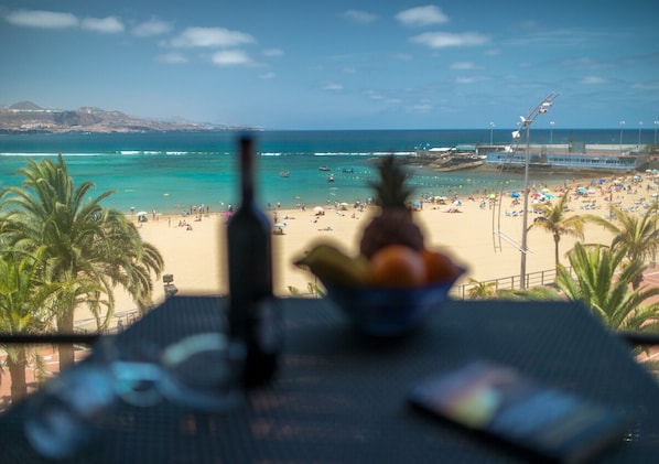 A beach view with a table in the foreground.