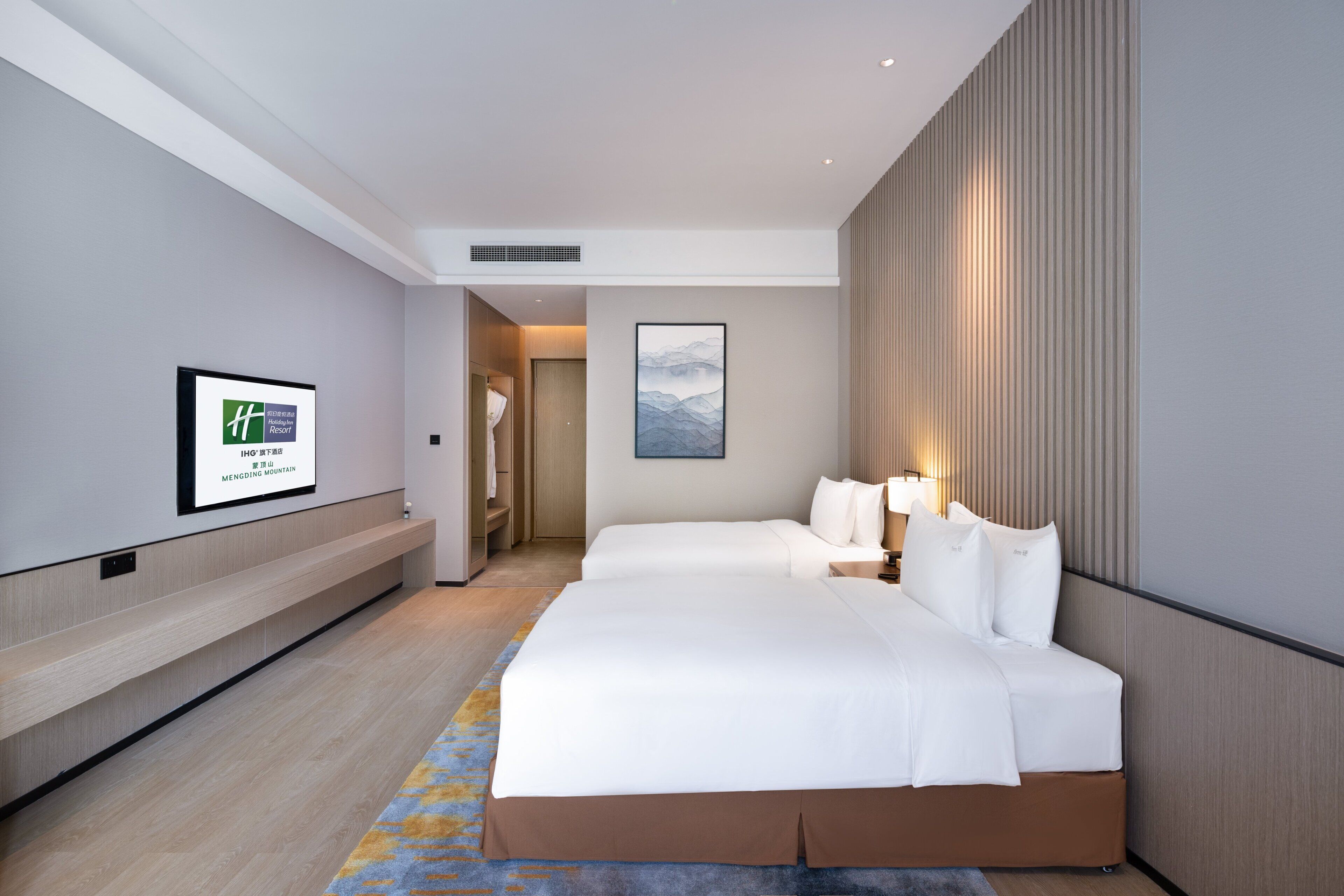A hotel room with two beds, a large window, a mounted artwork, and a visible bathroom door.