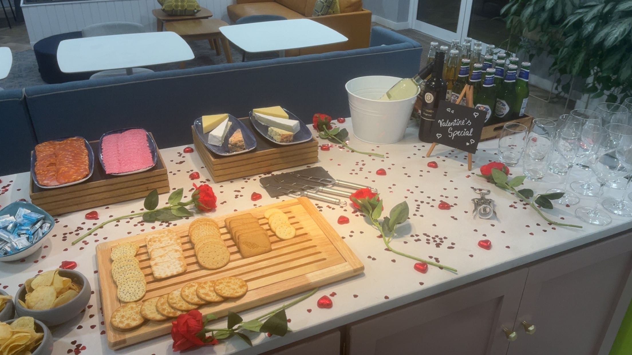 A buffet table with various food items and a selection of beverages.