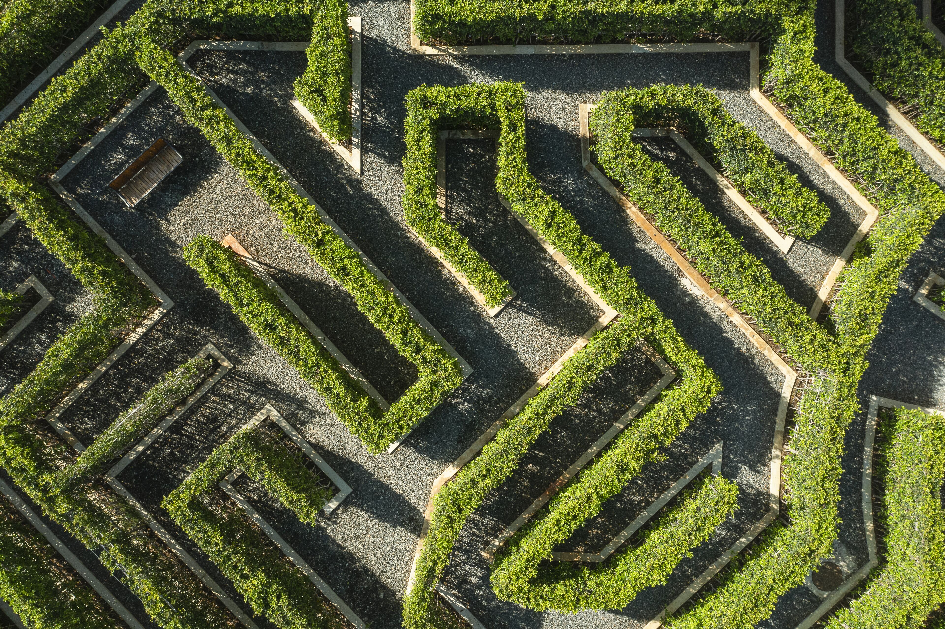 An aerial view of a maze-like garden with geometric pathways and trimmed hedges.
