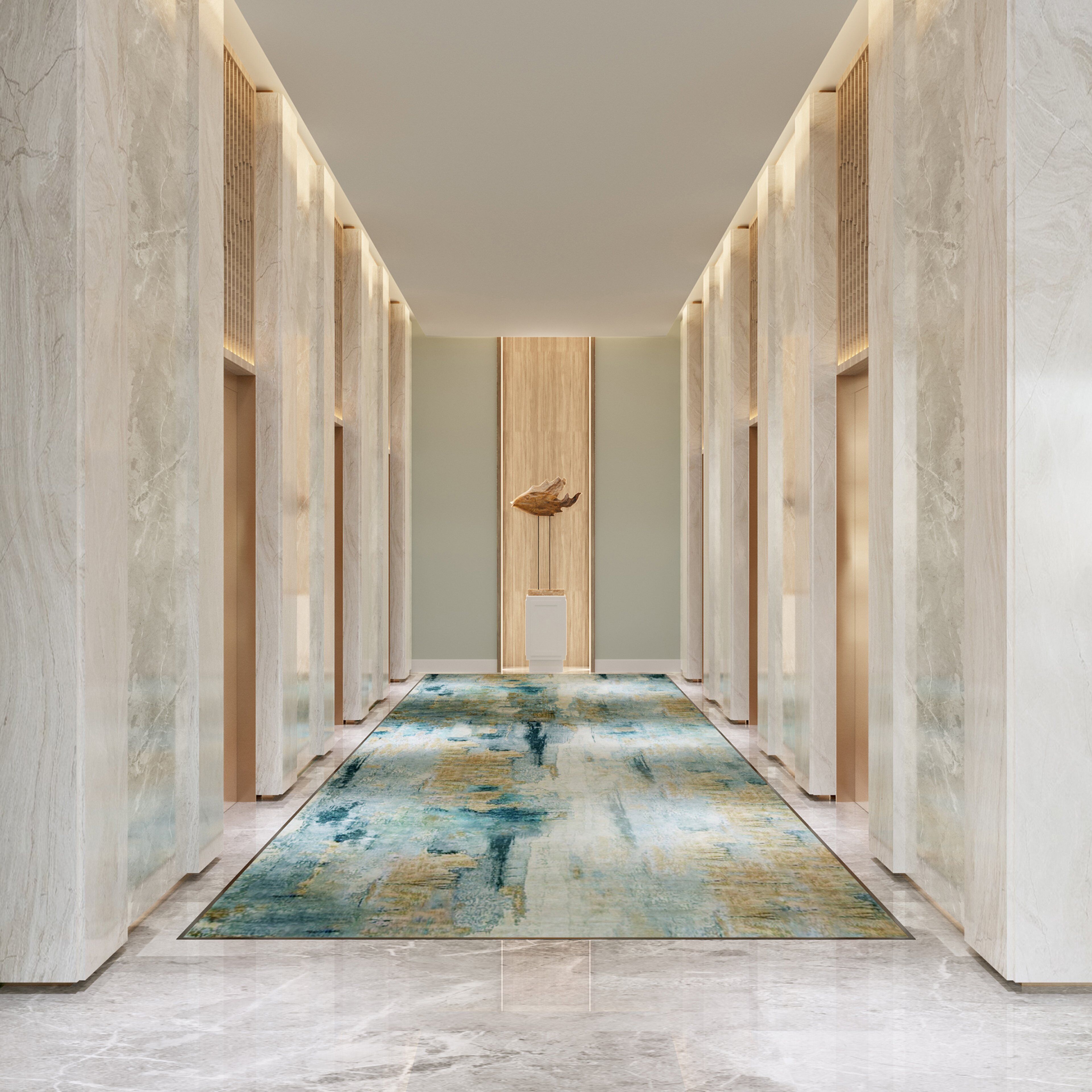 A hallway with marble walls, a wooden panel accent, and a blue abstract rug.