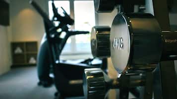 A gym with exercise equipment, including a 4KG weight plate.