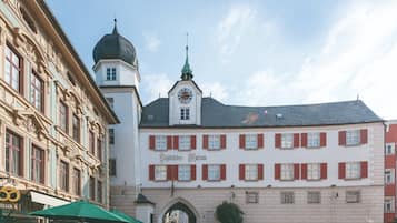 A historic building with a clock tower, arched entrance, and a sign reading "Gasthof zur Post".