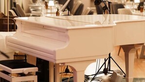 A modern hotel room with a piano, a desk, and a chair. - Patras Palace Hotel (Patras)