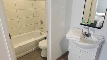 Bathtub, towels, soap, shampoo