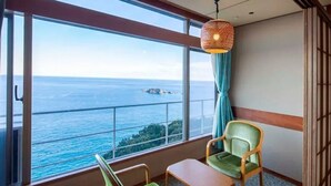 A balcony with a view of the sea, a hanging light fixture, and two chairs. - Hotel Urashima (Nachikatsuura)