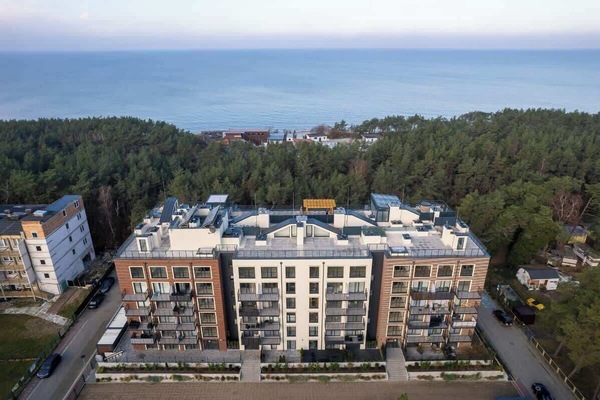 An aerial perspective of the complex surrounded by lush greenery, providing a sense of its integration with the natural environment.