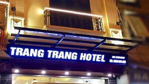 The exterior of Trang Trang Hotel with a prominent sign, a well-lit entrance, and a staircase leading to the door. - Trang Trang Premium Hotel (Hanoi)