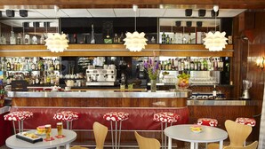 A bar area with a counter, multiple seating options, and a variety of bottles and glasses. - Bell Repos (Castell-Platja d'Aro)