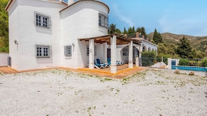 Relax on the covered patio with a seating area and small pool.