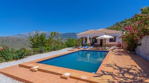 Relax by the serene pool surrounded by a tiled deck and lounge chairs.