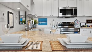A modern kitchen with white cabinets, stainless steel appliances, and a marble countertop. - PRIVATE Hot Tub with Valley Views!! (Colwood)