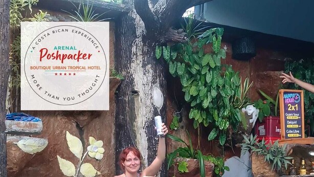 A woman sitting by a pool with a sign that reads 'Arenal Poshpacker Boutique Urban Tropical Hotel.' - Arenal Poshpacker Boutique Urban Tropical Hotel (La Fortuna)