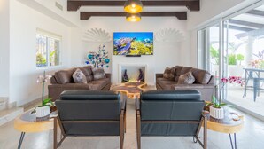 A modern living room with two sofas, a coffee table, and a fireplace.