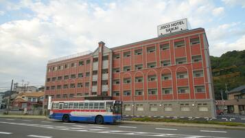 A multi-story building with a sign reading "JISCO HOTEL SAIKAI".