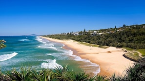 Enjoy a serene beachside escape with gentle waves lapping at the shore.
