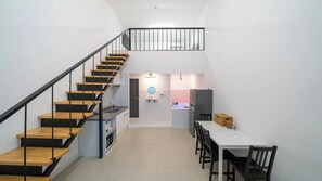 A modern interior with a staircase, kitchen, dining area, and a small bathroom. - Gapyeong Yeoldudal Spapension&camping (Gapyeong)