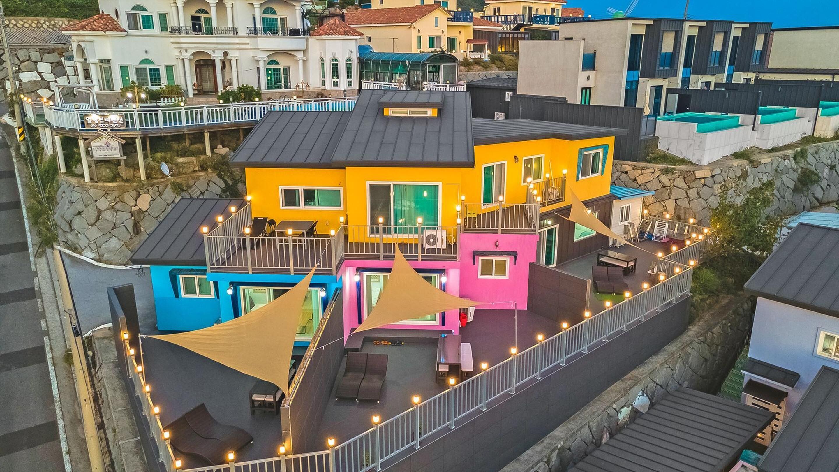 A multi-story building with balconies and outdoor seating areas.