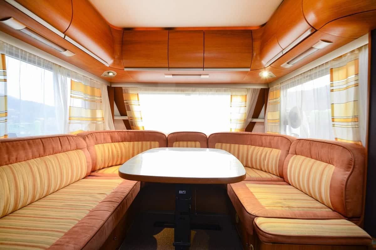 A cozy interior with a central table surrounded by cushioned seating.