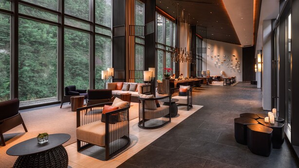 A spacious lobby with large windows, modern furniture, and a central seating area. - Ahn Lan Xinchang (Shaoxing)