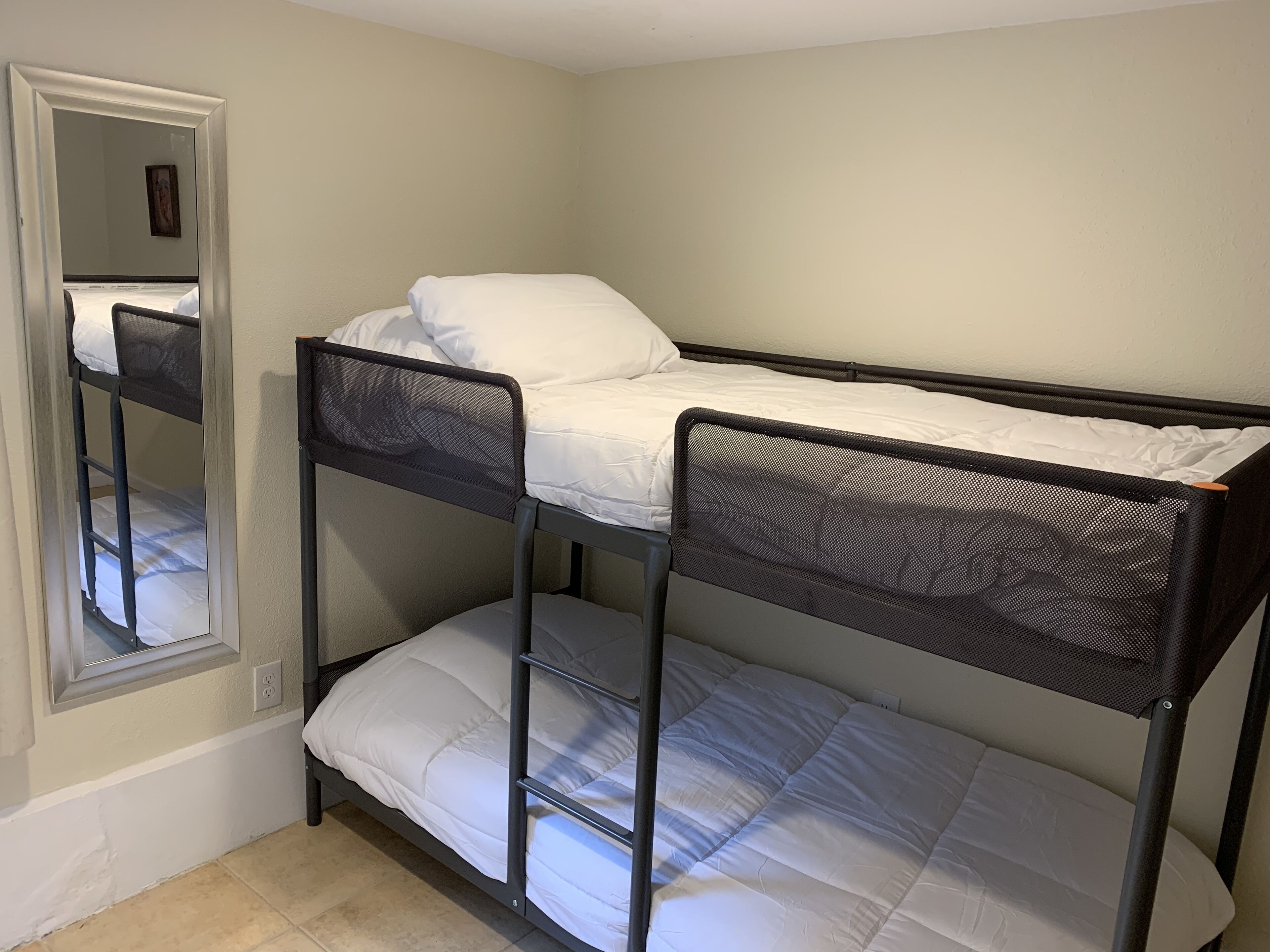 A bunk bed with a headboard and a lower bunk.