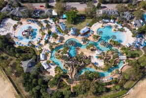 An aerial view of a resort with multiple swimming pools, sun loungers, and palm trees. - Immediately Adjacent to the Pool & Golf Course Views (Kissimmee)