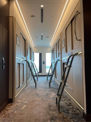 Corridors lined with doors and framed awards lead to a spacious window.