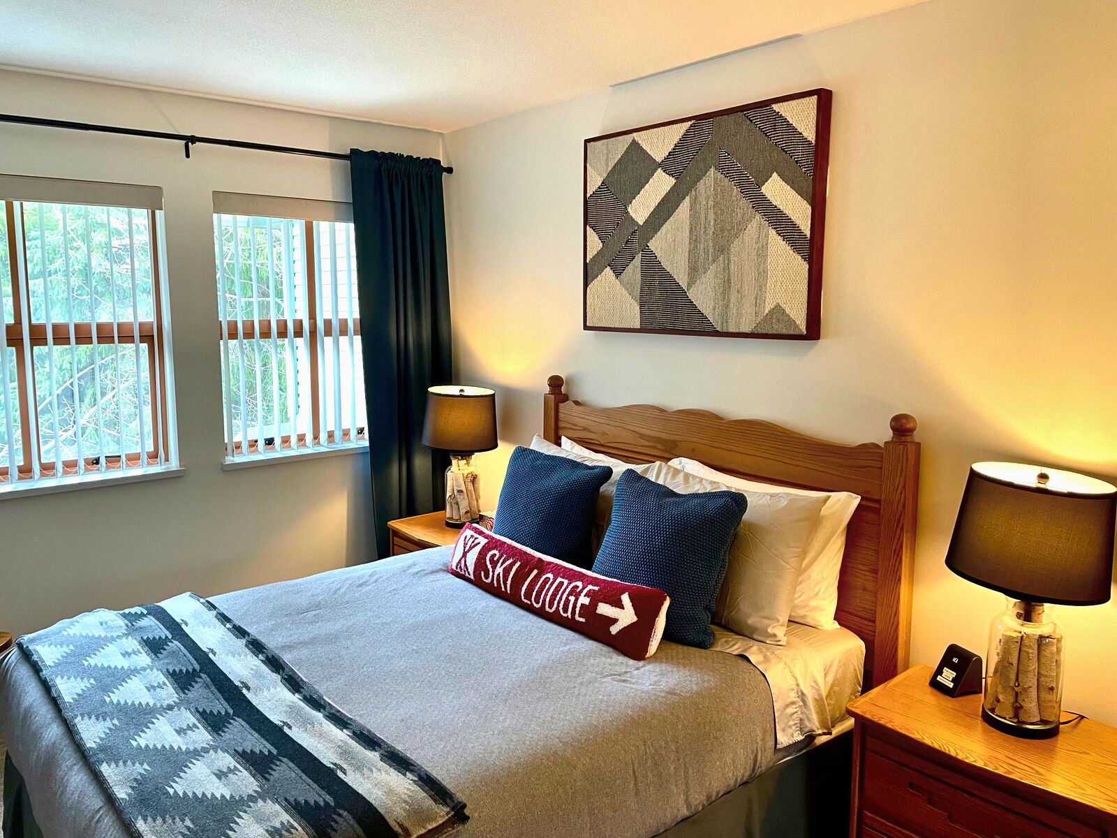 Primary bedroom with queen bed and black out blinds
