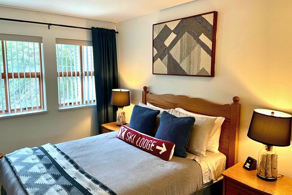 Primary bedroom with queen bed and black out blinds