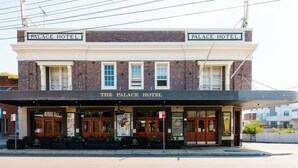 A two-story building with a sign reading "The Palace Hotel" at the top. - Palace Hotel Mortlake (Mortlake)
