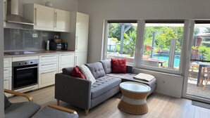 A modern kitchen with white cabinets, a built-in oven, and a microwave. - Moni's chicken farm Pure nature Outdoor pool for shared use (Nettetal)