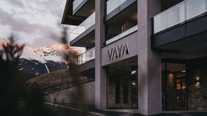 A modern building with a prominent 'VAYA' sign, featuring a multi-story structure with balconies and a stone facade. - VAYA Ladis (Ladis)