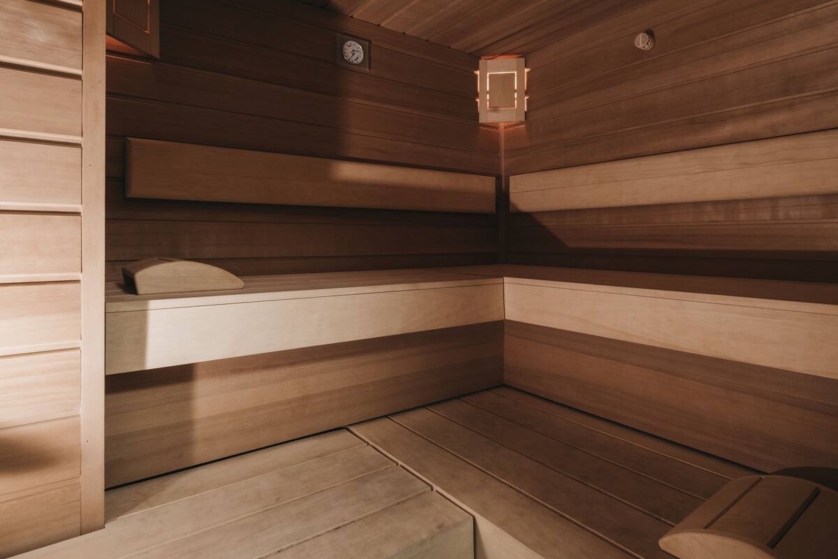 A sauna room with wooden walls and benches.
