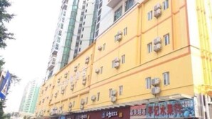 A multi-story building with a yellow facade, air conditioning units, and several windows.