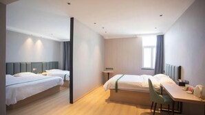 A modern hotel room with two single beds, a desk, and a chair. - Greentree Inn Anhui Xuancheng South Zhaoting Road Business Hotel (Xuancheng)