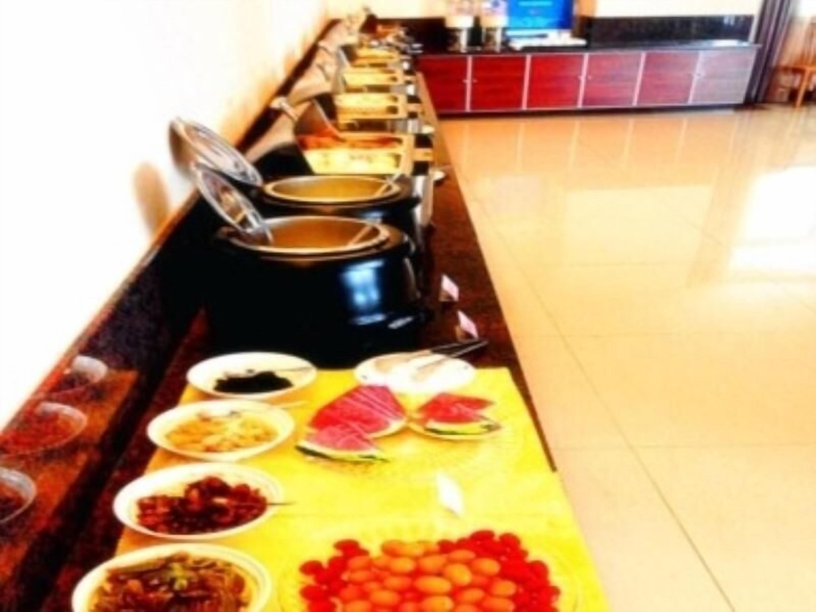 A buffet setup with various dishes and a counter in the background.