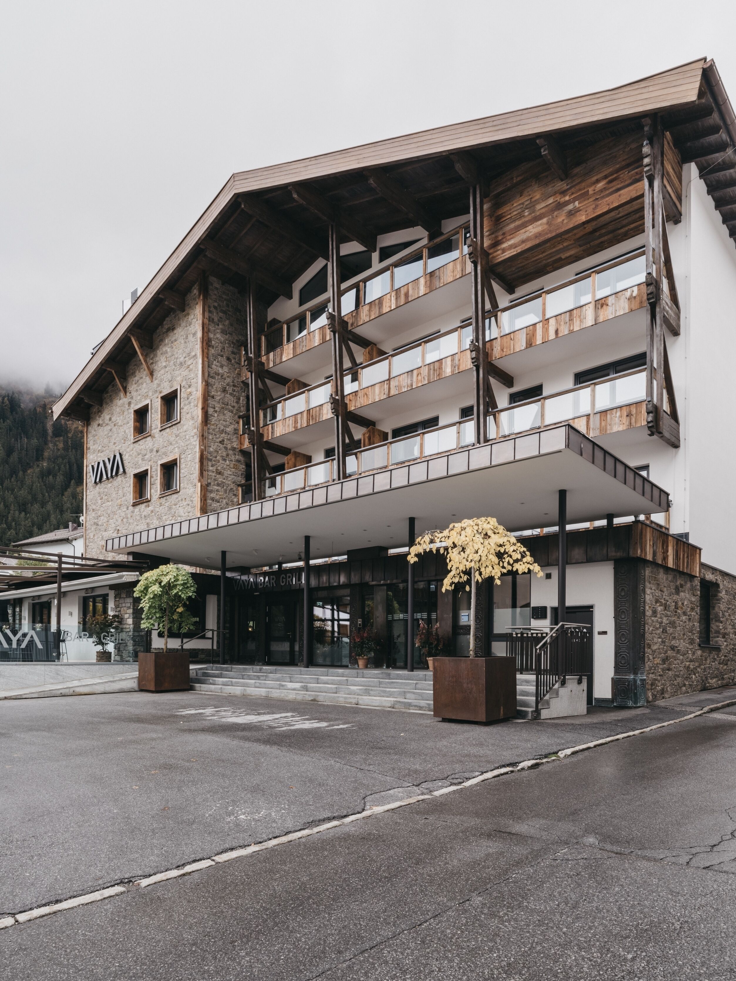 A multi-story building with a stone facade and wooden balconies.
