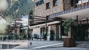 A multi-story building with a stone facade and a "VAYA" sign. - VAYA Galtür Paznaun (Galtur)